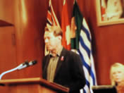 AIDS Vancouver Director, Bradford McIntyre, living infected with HIV since 1984, presents the We Care RED RIBBON Campaign Public Service Announcements: Stigma: The Silent Epidemic. Breaking Down the Silence and Safer Sex Practices, to Vancouver City Council at City Hall, Vancouver,Bc., Canada.