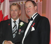 Bradford McIntyre & Dr. Colin Carrie (medal presenter on behalf of the Government of Canada. Bradford McIntyre recieves The Queen Elizabeth II Diamond Jubilee Medal for excellence in the field of HIV/AIDS in Canada, on November 27, 2012, Chateau Cartier Hotel, Gatineau, Quebec.