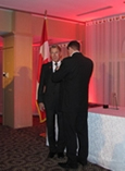 Bradford McIntyre presented with the Queen Elizabeth II Diamond Jubilee Medal and Medal pinned by Dr. Colin Carrie, Parliamentary Secretary to the Minister of Health