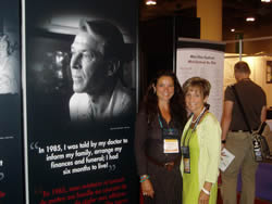 Photo: AIDS 2006: Lise and Jacqueline Turpin, standing beside 8 ft. Poster Portrait of Bradford McIntyre, living with HIV, providing a human FACE to HIV/AIDS in Canada in 2006. Exhibition Hall at the XVI International AIDS Conference, August 13 - 18, 2006, Toronto, Canada.