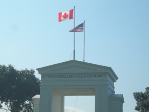 Peace Arch at the border between Canada and the United States. Atop the Peace Arch Monument are the words BRETHREN DWELLING TOGETHER IN UNITY. Photo Credit: Bradford McIntyre
