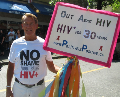Bradford McIntyre, HIV Survivor since 1984. Bradford marched proudly along the 36 ANNUAL Vancouver PRIDE PARADE route carrying his homemade sign which read: OUT ABOUT HIV, HIV+ 30 YEARS, wearing a T-Shirt with the words: NO SHAME ABOUT BEING HIV+, to fight HIV/AIDS Stigma.