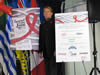 AIDS Vancouver Board Member Bradford McIntyre with We Care RED RIBBON Campaign Posters - HIV/AIDS : Together We Can Protect Each Other. Spread The Love, Stop The Virus.