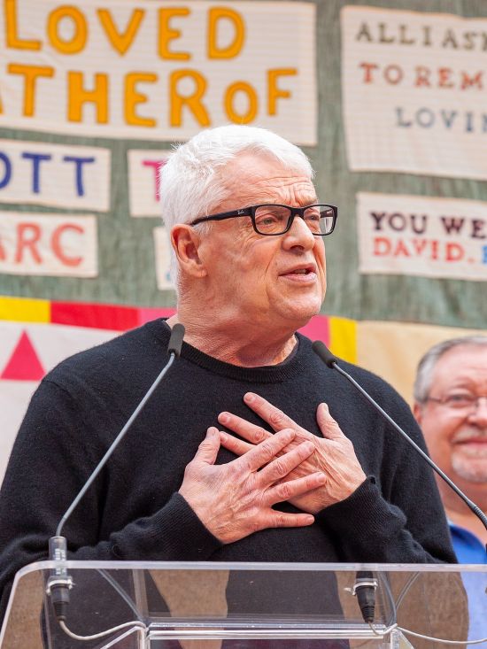 Cleve Jones, activist and founder of the quilt, in front of a panel. Image taken from Wikipedia.
