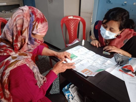 Client taking a HIV self-test for the first time with support from a trained provider as assisted self-testing in India (© PATH India) Client taking HIV self-test
