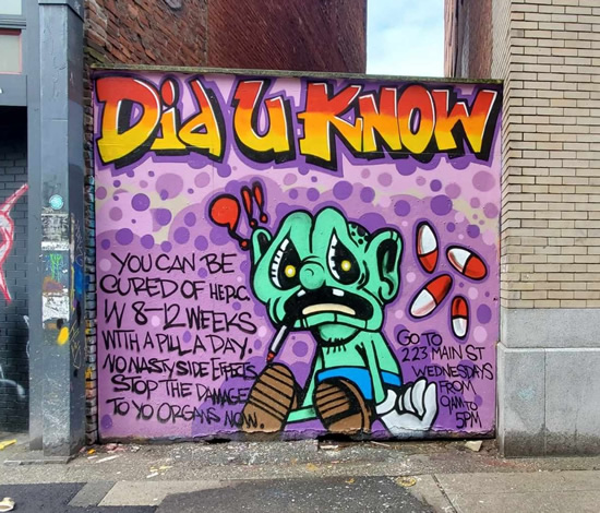 Graffiti text: You can be cured of Hep C Green cartoon character with red and white pills Graffiti text: You can be cured of Hep C Green cartoon character with red and white pills