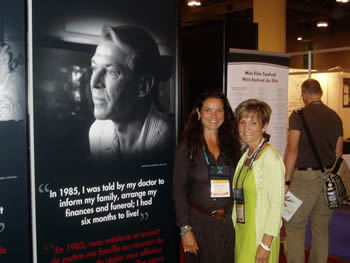 AIDS 2006: Jacqueline and Lise Turpin, Lise standing beside 8 ft. Poster Portrait of Bradford McIntyre, providing a human FACE to HIV/AIDS in Canada in 2006. Exhibition Hall at the XVI International AIDS Conference, August 13 - 18, 2006, Toronto, Canada
