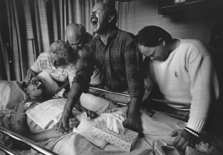 Moments before his death, Tom Fox is surrounded by grieving loved ones at Sacred Heart Hospital in Eugene, Oregon, on July 11, 1989. Michael Schwarz, the Atlanta Journal-Constitution