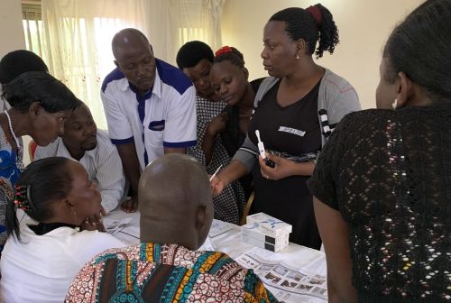 Ms. Prisca Asiimwe, provides instruction on use of oral swab rapid HIV tests