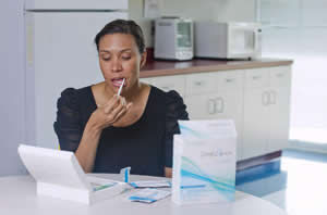 A model demonstrates the OraQuick test, which detects the presence of HIV in saliva collected using a mouth swab. The test is designed to return a result within 20 to 40 minutes. The U.S. Food and Drug Administration approved the first over-the-counter HIV test July 3, 2012, Photo Credit: Chuck ZOVKO/AP
