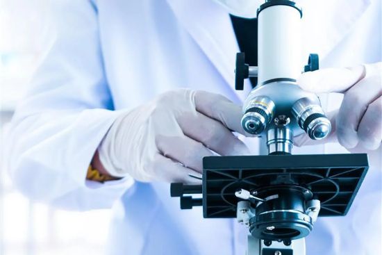 Image: Researcheer works with a microscope Researcheer works with a microscope