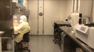 Researchers at work in a containment lab
