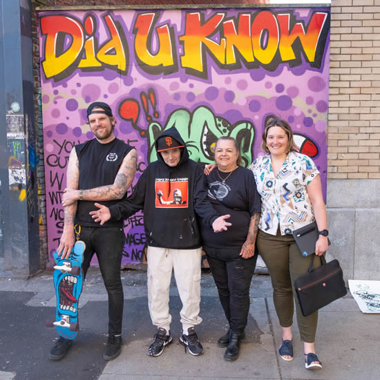  Trey Helten, Smokey D, Pam Young and Sofia Bartlett stand in front of a mural created to provide info about hep C treatment to people in Vancouver's Downtown East Side.