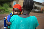 Veronica carries her youngest child, Mubarak (9 months), at the hospital in Wau, South Sudan