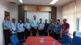 The research team poses with officials from the Indonesia Department of Corrections. Gabriel Culbert, associate professor in the Department of Population Health Nursing Science at UIC is 5th from right; collaborator and UIC alumnus Aging Waluyo is 3rd from right.