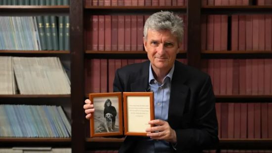 Michael Malim holding picture frame