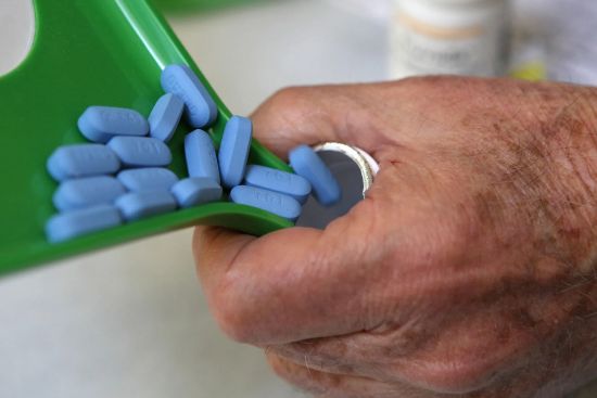 A pharmacist pours pills of Truvada - (JUSTIN SULLIVAN/GETTY IMAGES)