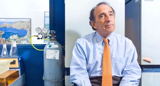 Jay Levy, MD Jay Levy sits stylishly in bright yellow tie next to a helium tank