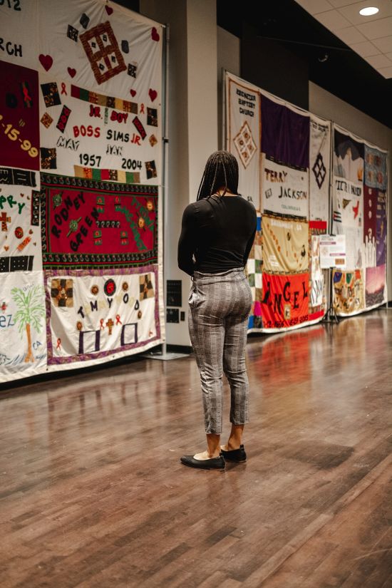 A visitor looks at the National AIDS Memorial Quilt exhibit that is on display. The worlds largest community project is 54-thousand tons and spreads over 54 miles as tribute to people who lost their lives to HIV and AIDS.